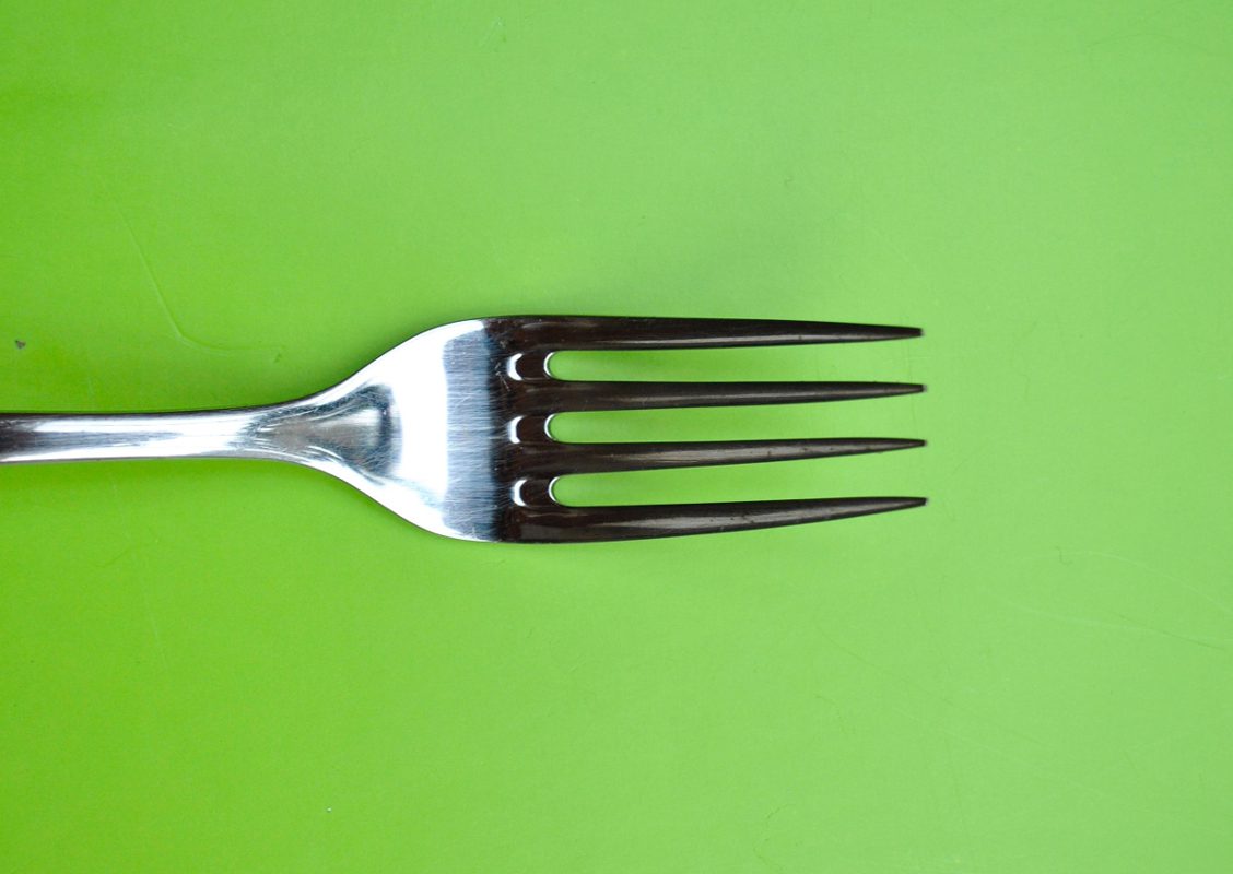 A fork on a green background